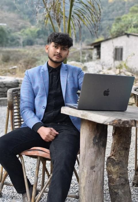 Sapun Lamichhane, Founder & CEO of Arcetis, working on a laptop in Pokhara, Nepal